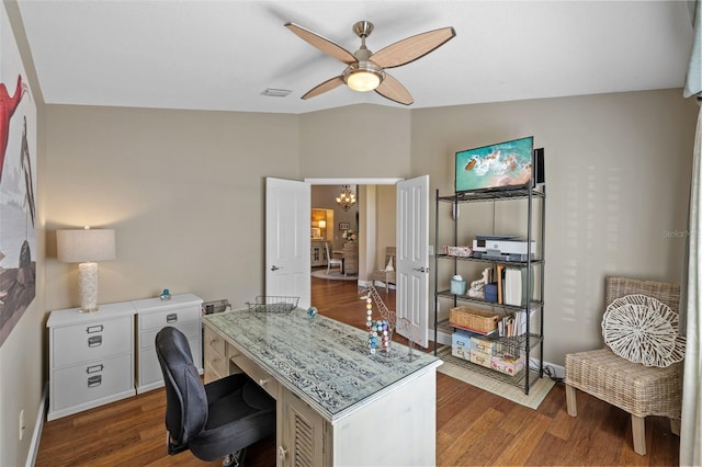 office with dark hardwood / wood-style floors and ceiling fan with notable chandelier