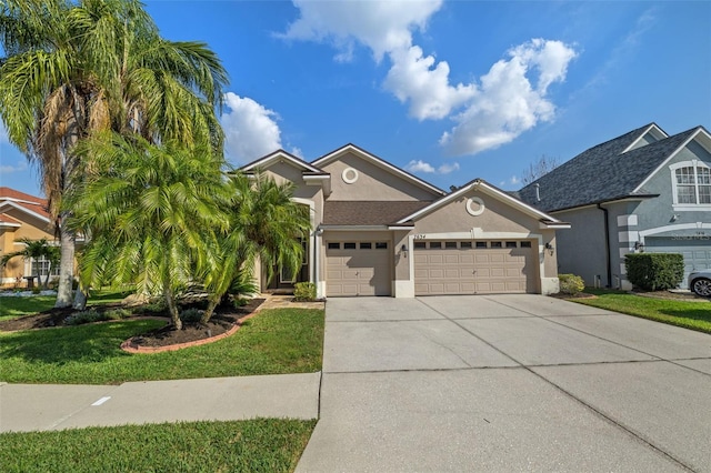 view of front of home featuring driveway, a front lawn, an attached garage, and stucco siding