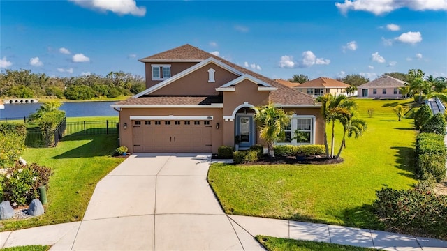 view of front of property featuring a water view, a garage, and a front lawn