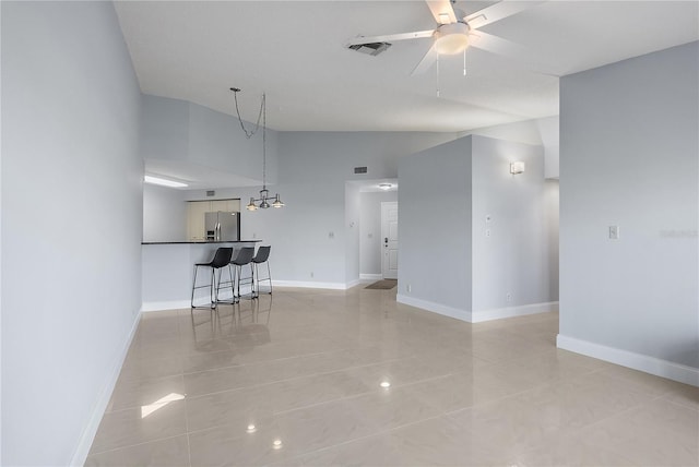 unfurnished living room with ceiling fan and vaulted ceiling