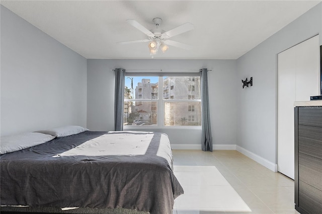 tiled bedroom with ceiling fan