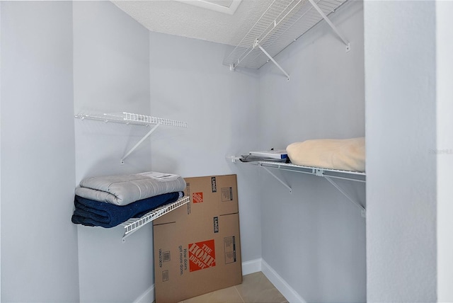 spacious closet featuring light tile patterned flooring