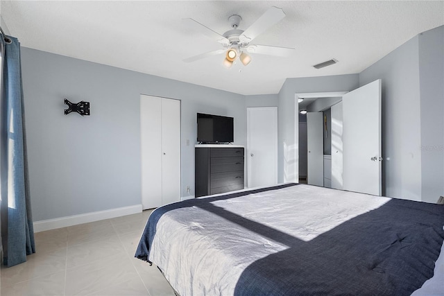 tiled bedroom with ceiling fan