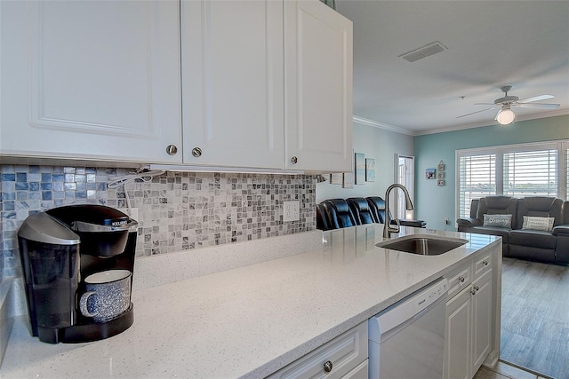 kitchen featuring white cabinetry, dishwasher, sink, and light stone counters