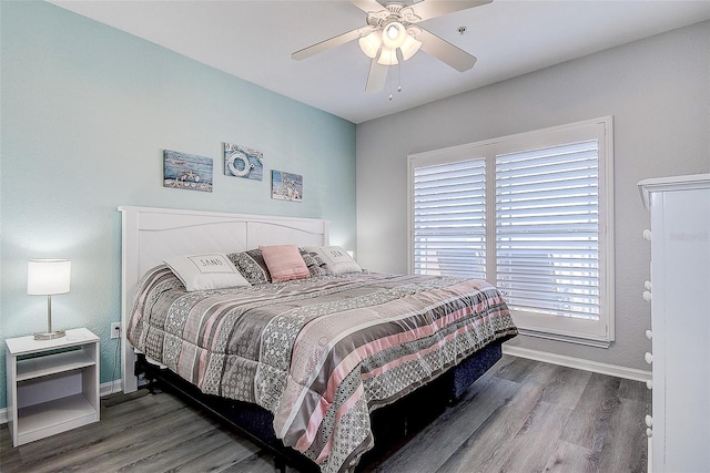 bedroom with dark wood-type flooring and ceiling fan