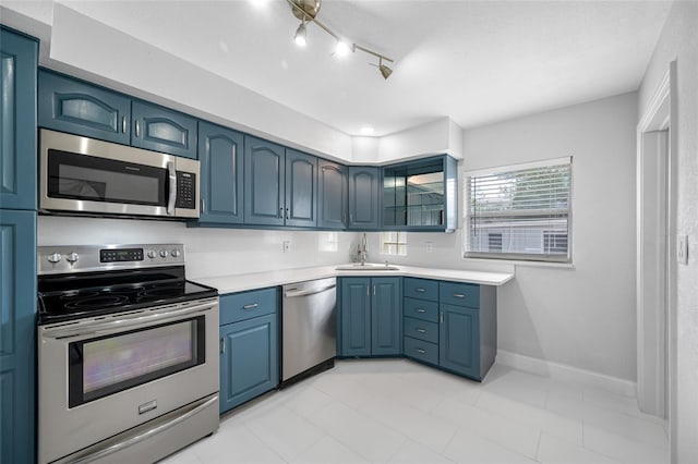 kitchen featuring blue cabinets, sink, and appliances with stainless steel finishes