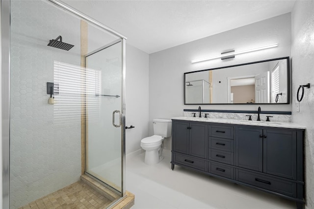 bathroom featuring vanity, toilet, and an enclosed shower