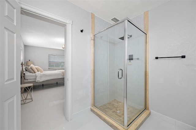 bathroom with a shower with door