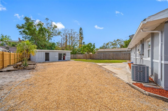 view of yard featuring central AC and a patio