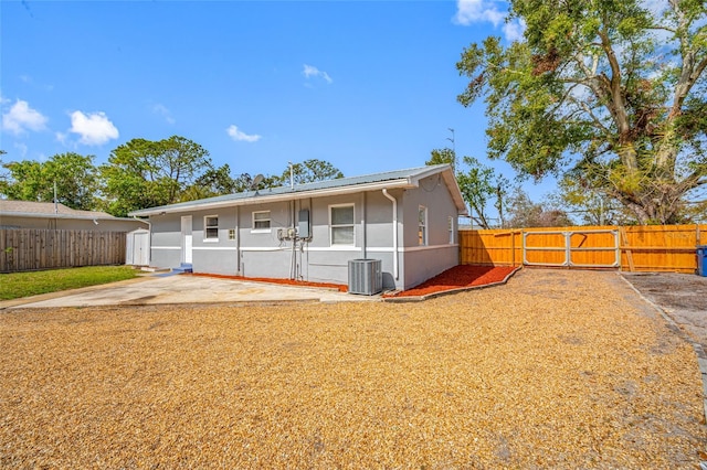 rear view of house with a patio and central air condition unit