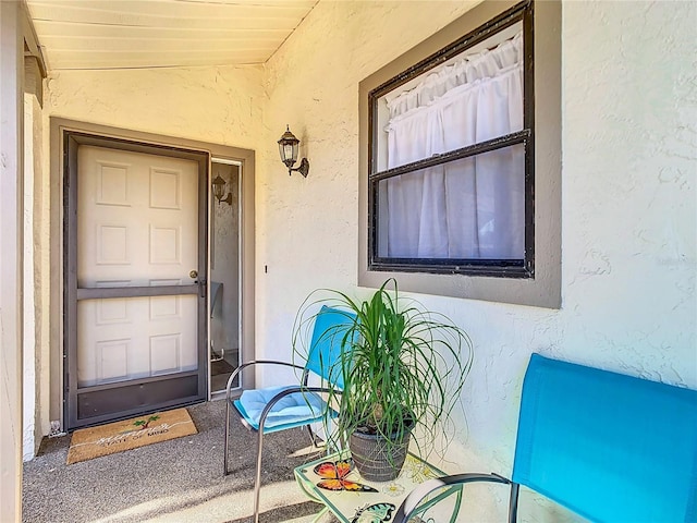 view of exterior entry with stucco siding