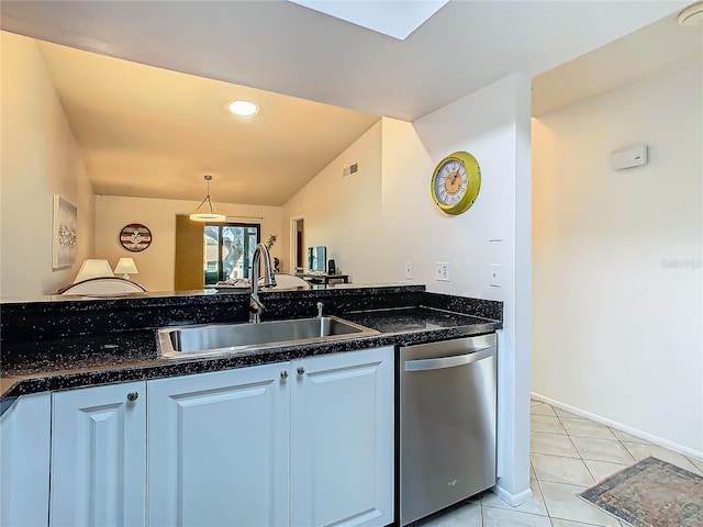 kitchen with pendant lighting, sink, light tile patterned floors, white cabinetry, and stainless steel dishwasher