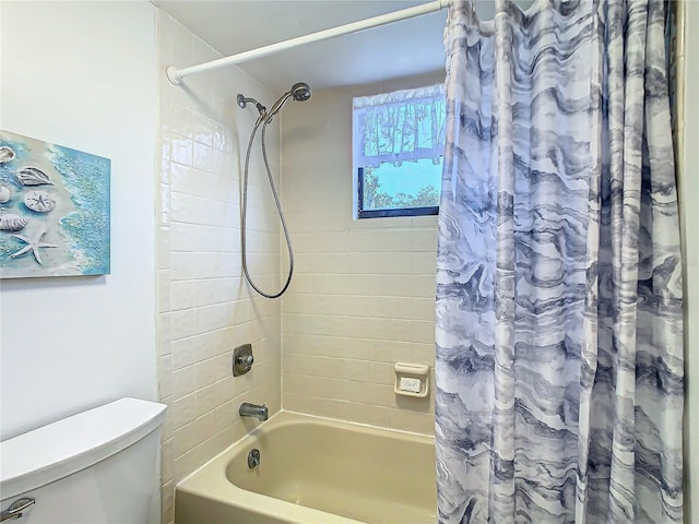 bathroom featuring shower / bath combo and toilet