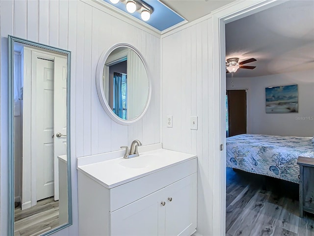 bathroom featuring hardwood / wood-style flooring, vanity, and ceiling fan