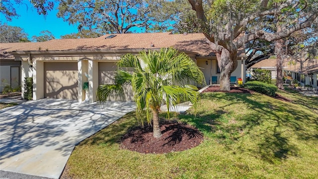 view of front of home featuring a garage and a front lawn