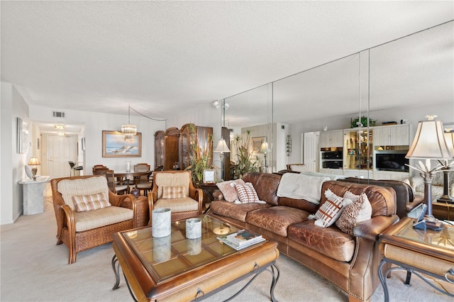 living room featuring light carpet and a textured ceiling