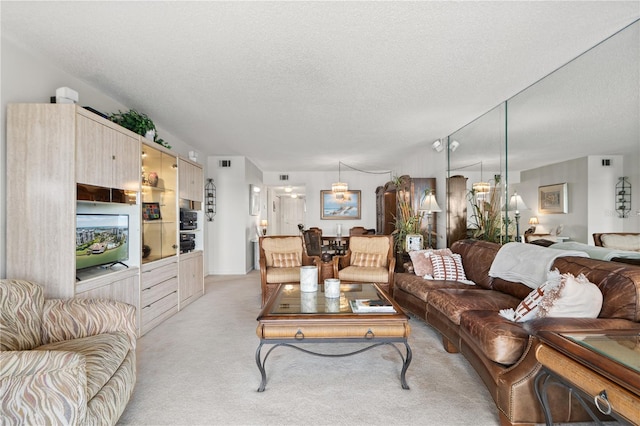 living room with light carpet and a textured ceiling