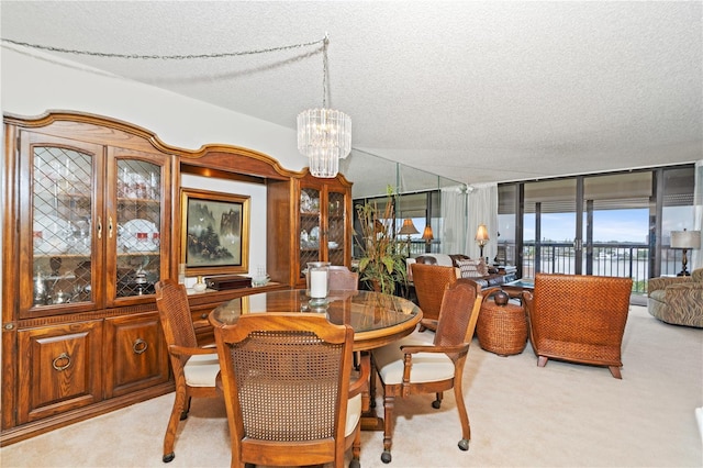 carpeted dining space featuring floor to ceiling windows, a notable chandelier, and a textured ceiling