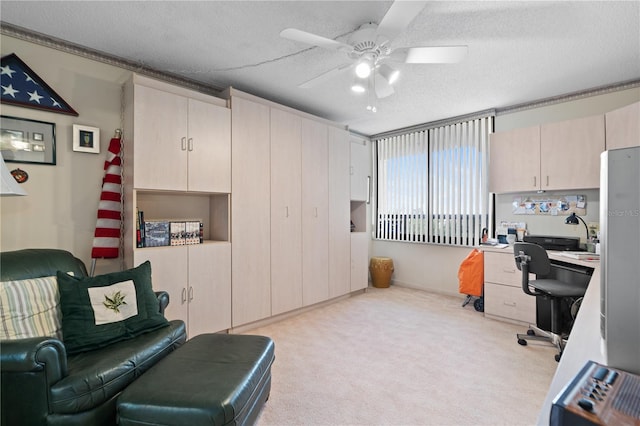 office with ceiling fan, light carpet, and a textured ceiling