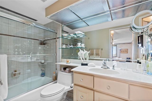 full bathroom featuring vanity, toilet, and combined bath / shower with glass door