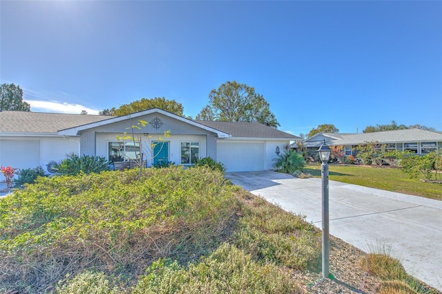 single story home featuring an attached garage, brick siding, concrete driveway, and a front yard