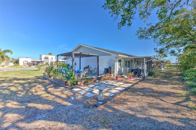 back of house featuring central AC, a patio area, and a sunroom