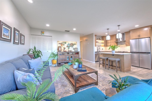 living room with recessed lighting, visible vents, and light tile patterned floors