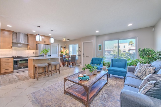 living area featuring light tile patterned floors and recessed lighting