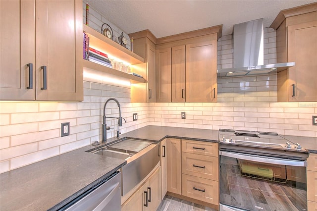 kitchen with dark countertops, stainless steel electric range oven, wall chimney exhaust hood, open shelves, and a sink