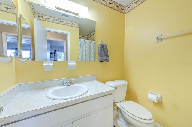 bathroom featuring vanity and toilet