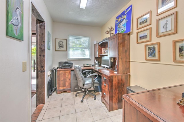 office featuring light tile patterned floors and a textured ceiling