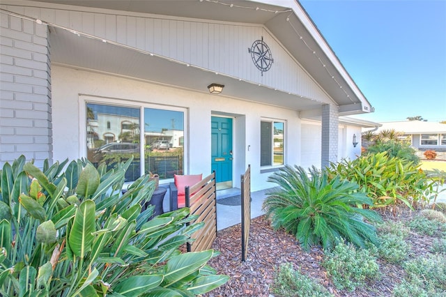 entrance to property featuring brick siding