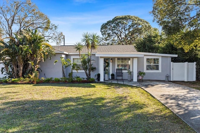 single story home featuring covered porch and a front yard