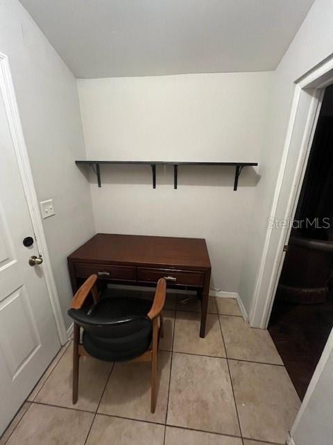 office with light tile patterned floors and baseboards