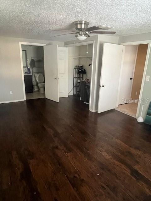 empty room featuring baseboards, a textured ceiling, a ceiling fan, and wood finished floors