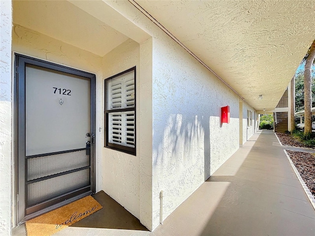 view of exterior entry with stucco siding