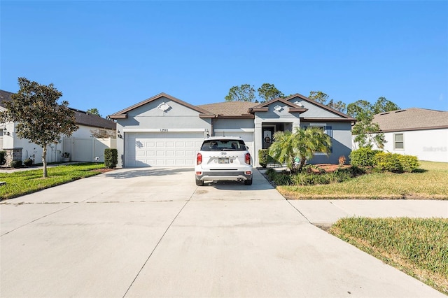 view of front of home featuring a garage and a front lawn