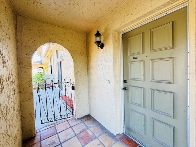 property entrance with stucco siding