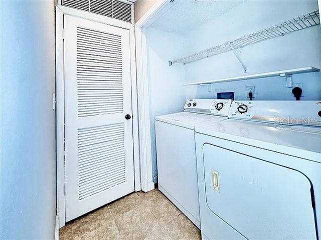 clothes washing area featuring laundry area and washer and clothes dryer