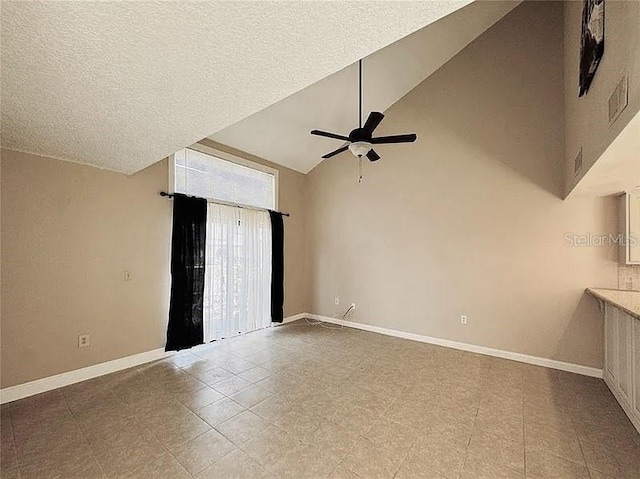 empty room featuring a textured ceiling, high vaulted ceiling, a ceiling fan, and baseboards