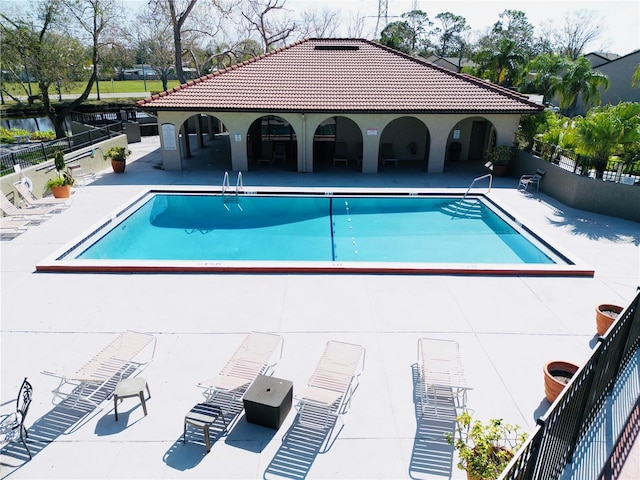 pool featuring a patio area and fence