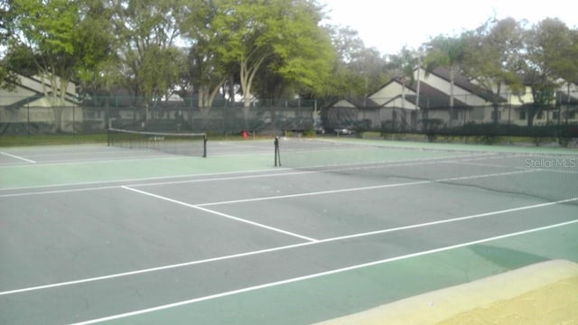 view of sport court with fence