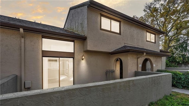 exterior space featuring fence and stucco siding