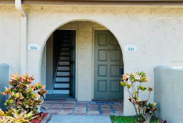 entrance to property featuring stucco siding