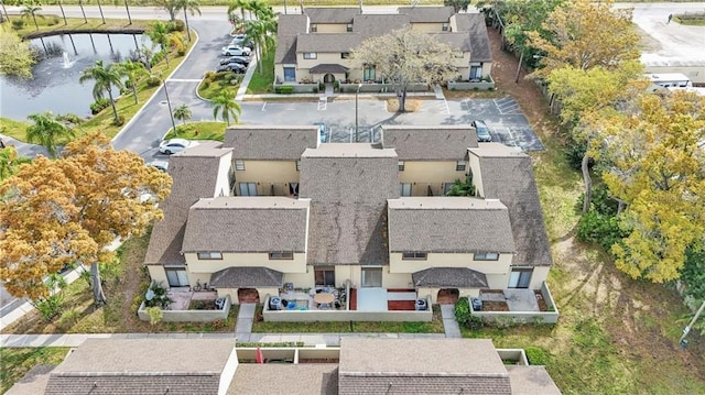 birds eye view of property featuring a water view and a residential view