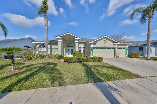 ranch-style home with a garage and a front lawn