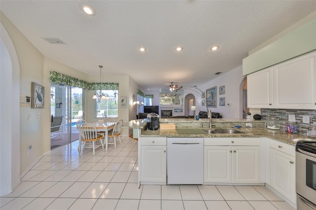 kitchen featuring light stone counters, white cabinets, white dishwasher, and kitchen peninsula