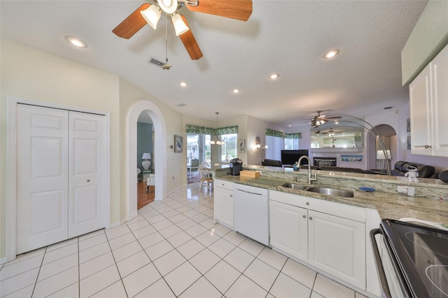 kitchen featuring sink, stainless steel range with electric cooktop, white cabinets, white dishwasher, and light stone countertops