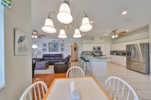 dining area featuring ceiling fan and light tile patterned floors