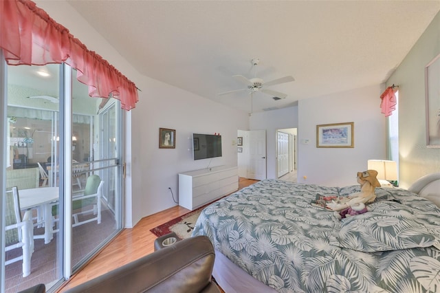 bedroom with lofted ceiling, access to exterior, wood-type flooring, and ceiling fan